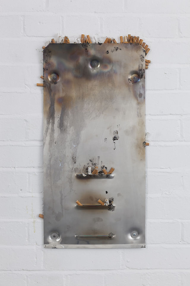 Marlie Mul, Air Vent / Butt Stop (Lucifer Match), 2012, steel, cigarette butts, paper, ashes, sand, glue, chewing gum, 30&nbsp;×&nbsp;60 cm