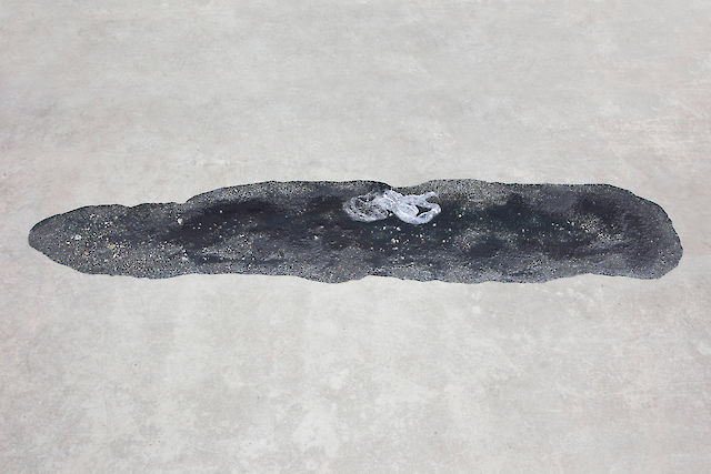 Marlie Mul, Puddle (Black Suburb), 2013, Sand, stones, resin, plastic bags, 2&nbsp;×&nbsp;180&nbsp;×&nbsp;36 cm
