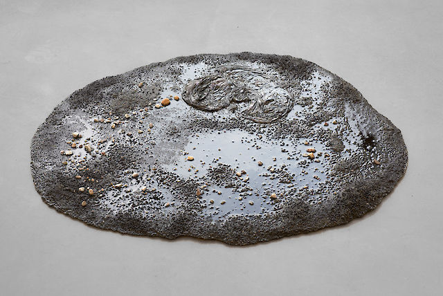 Marlie Mul, Puddle (Green Drap), 2013, sand, stones, resin, plastic bag, 2&nbsp;×&nbsp;95&nbsp;×&nbsp;70 cm